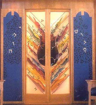 The inner surfaces of the cherry-wood doors are painted with a design of Hebrew letters against a blue background